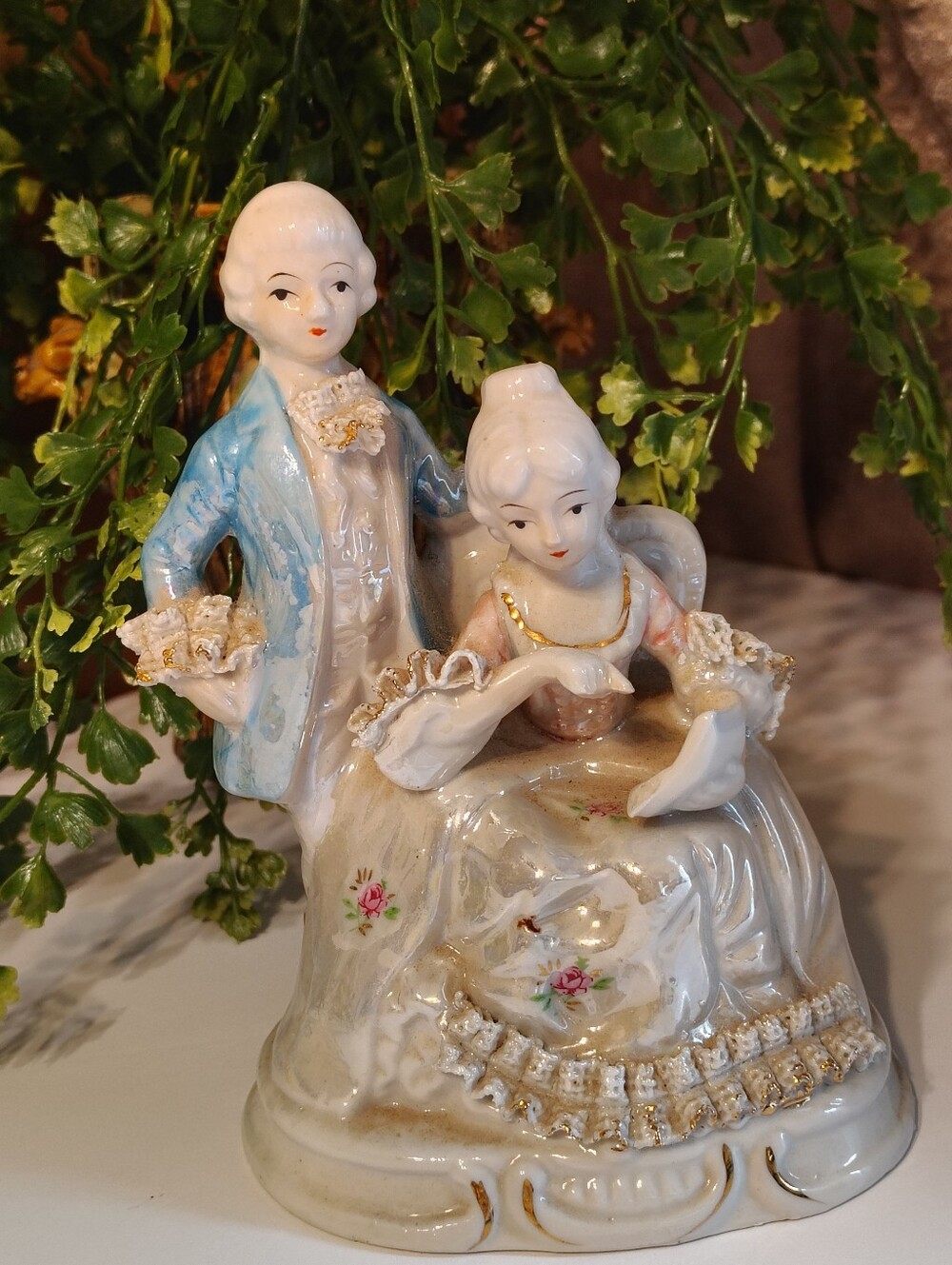 Porcelain Victorian Figure with  Gold gilt detailing and floral accents.